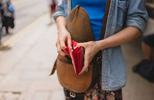 woman looking through her wallet