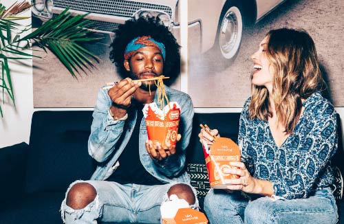 Two friends eating fast food together