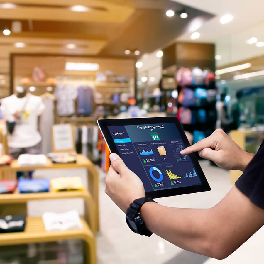 A man holds a tablet and works on inventory