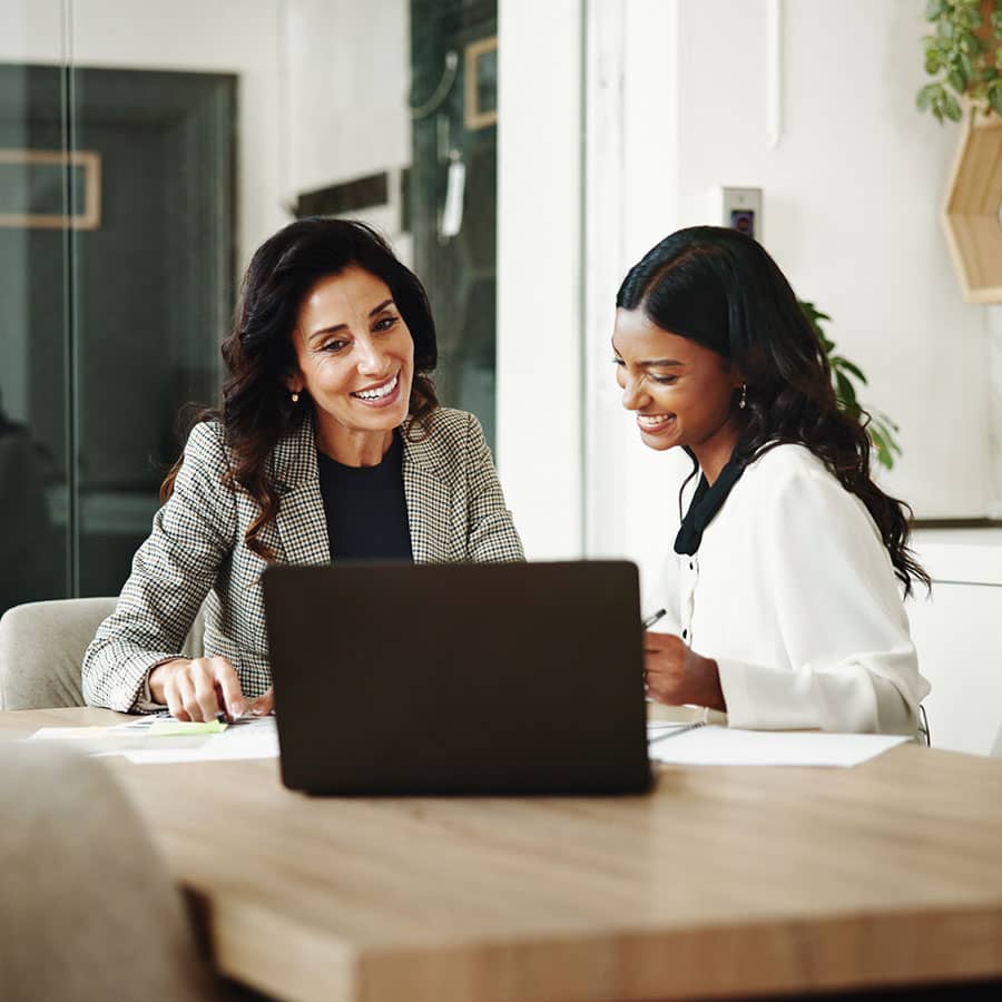 Two women at a table discuss a Commercial Line of Credit