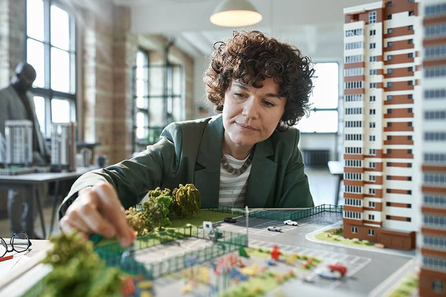 An architect works on a building model