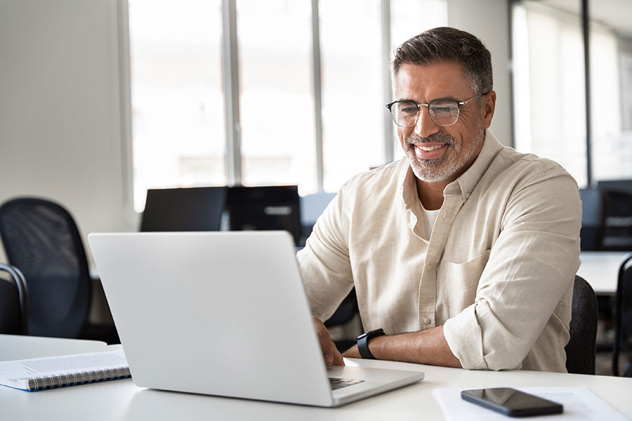 A business man using a laptop at his desk