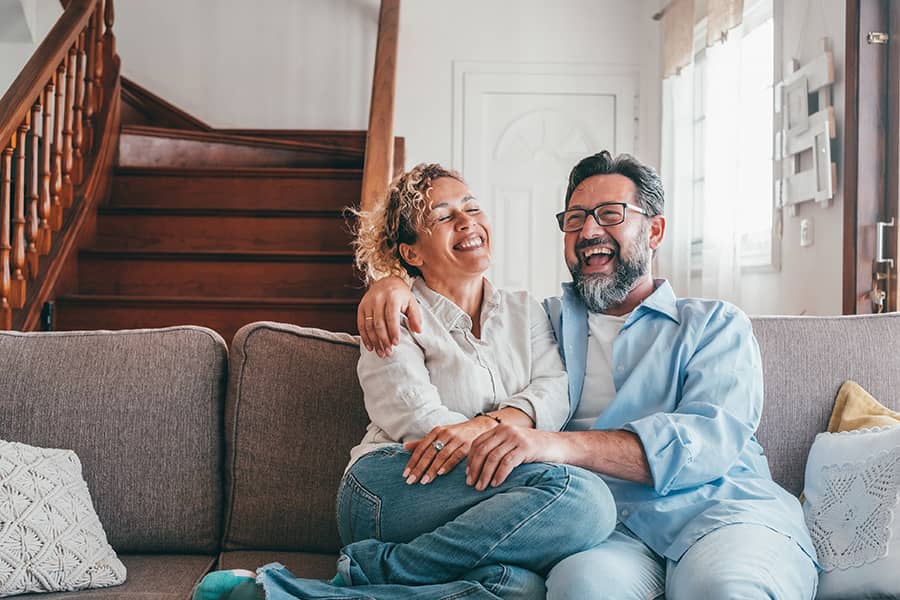A couple sitting together on the couch
