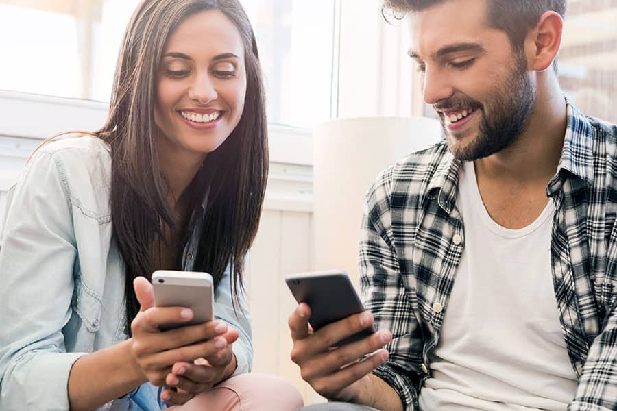 Two female hands holding phones