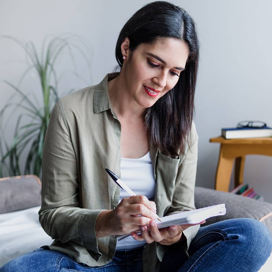 A woman writing in a notebook