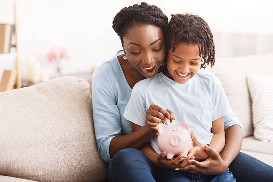 A mother and child with a piggy bank