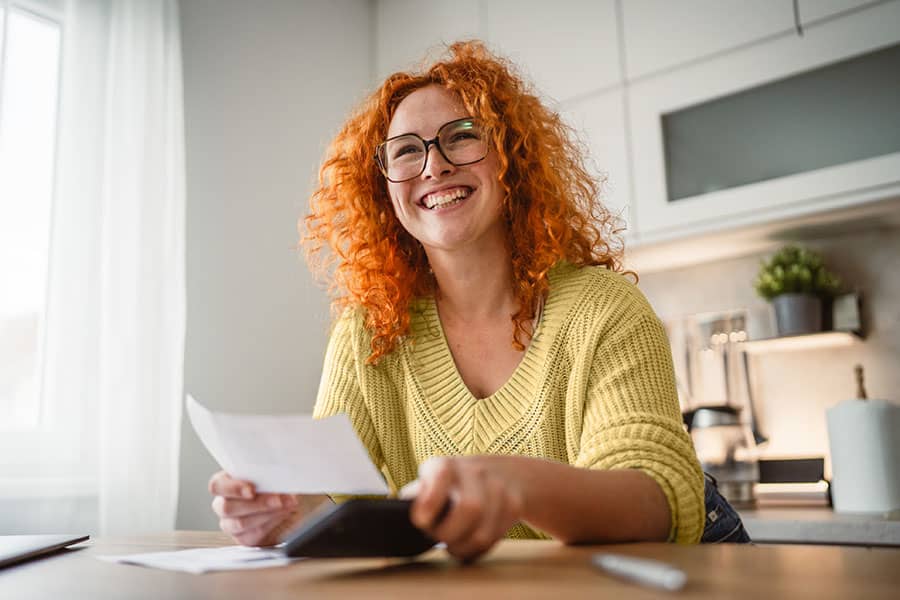A smiling woman holding a check