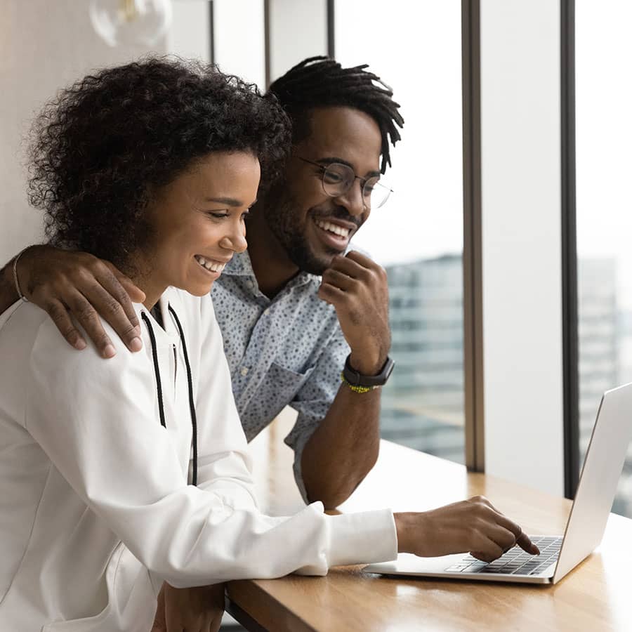 A couple sending a wire using their laptop