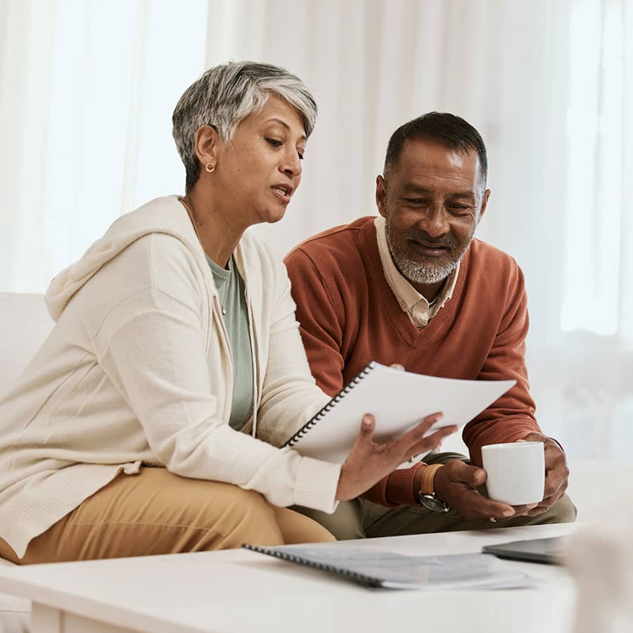 A couple sits on the couch and discusses their investments