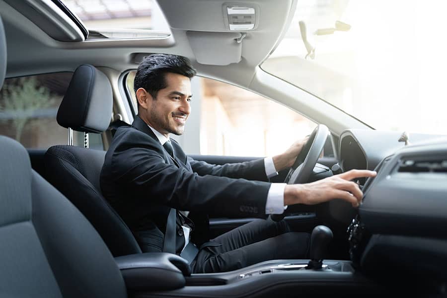 A man sitting in his new car